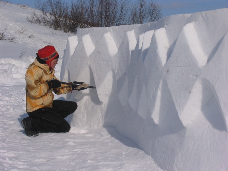 Saami girl carving snow-art.