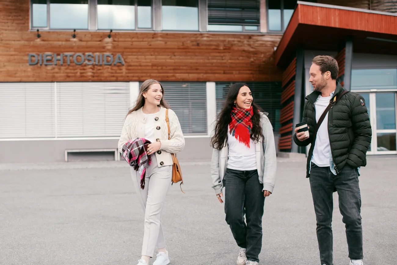 Tre studenter foran bygg