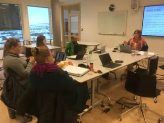 5 people sitting around a table